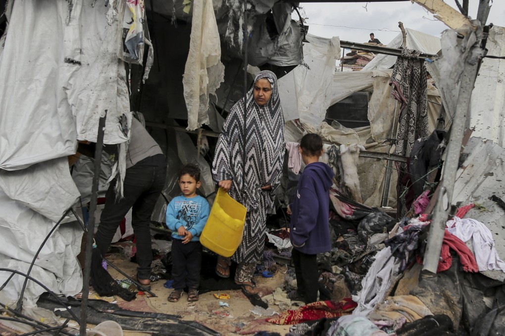 Displaced Palestinians inspect their tents destroyed by Israel’s bombardment. Photo: AP