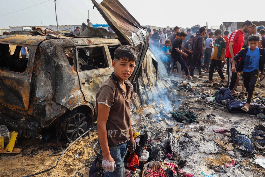 Palestinians gather at the site of an Israeli strike on a camp area housing internally displaced people in Rafah amid ongoing battles between Israel and the Palestinian Hamas militant group. Photo: TNS