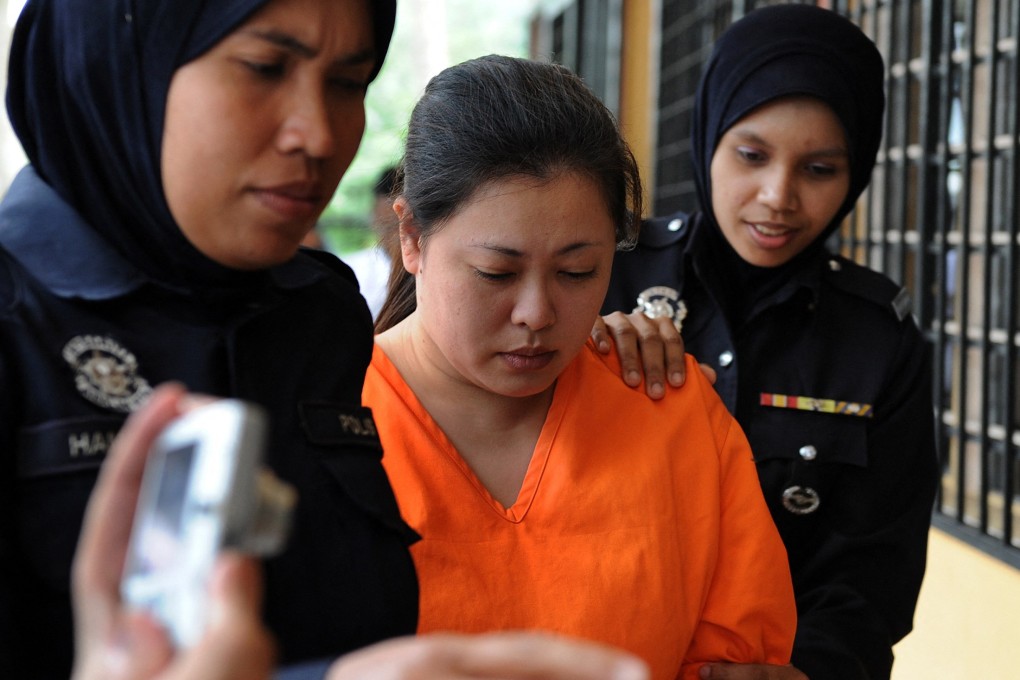 Malaysian policewomen escort Japanese national Mariko Takeuchi (centre) at a sessions court in Sepang, on the outskirts of Kuala Lumpur, in 2010. Photo: AFP