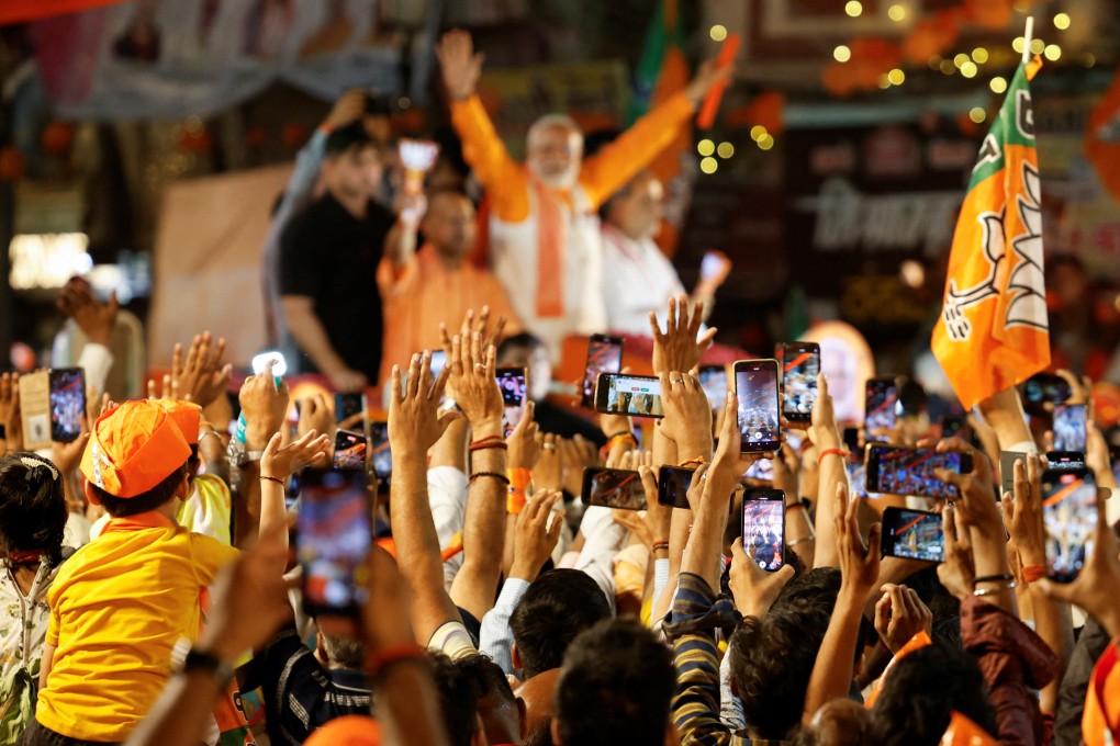Supporters use their smartphones to take pictures of India’s Prime Minister Narendra Modi during an election roadshow for his ruling Bharatiya Janata Party in Varanasi on May 13. Photo: Reuters