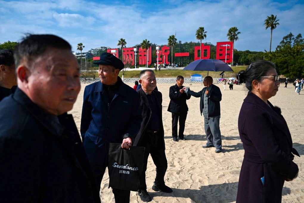 A giant sign reading “One Country, Two Systems, Unify China” is seen on the beach in Xiamen, Fujian, the closest mainland province to Taiwan. Photo: AFP