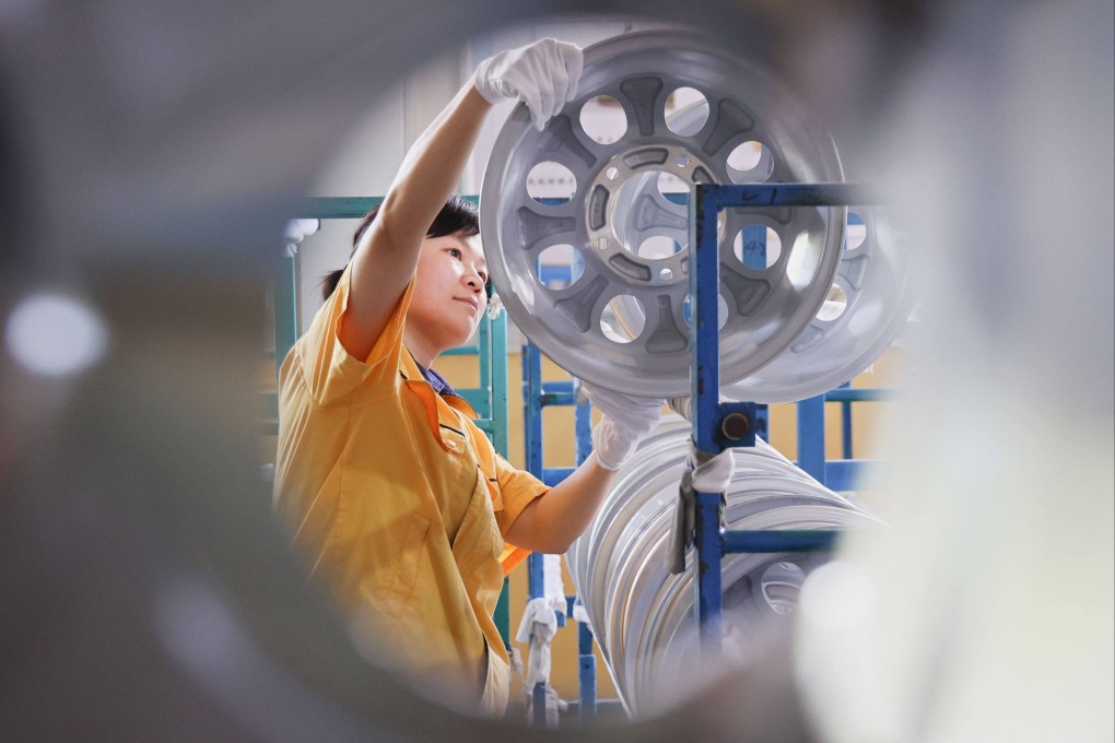 An employee works on a car wheel rim production line at a factory in Binzhou, in eastern China’s Shandong province, on Monday. Photo: AFP