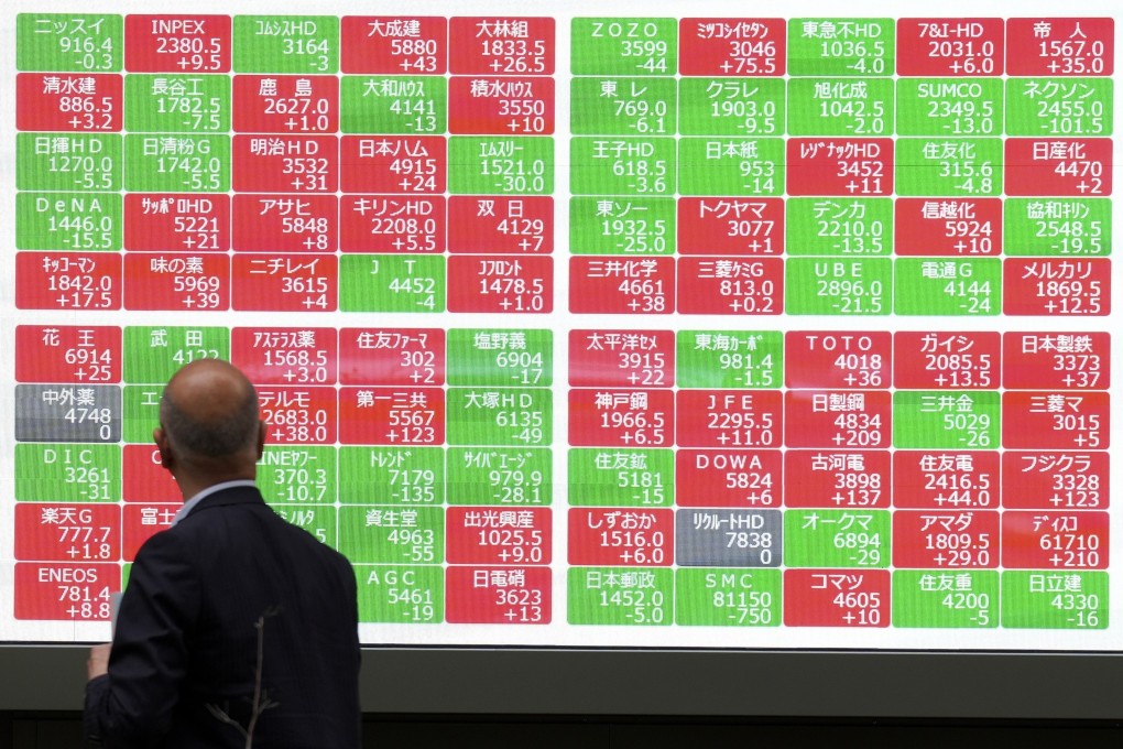 A man looks at an electronic stock board showing Japan’s Nikkei 225 index at a securities firm in Tokyo, on May 27. Photo: AP
