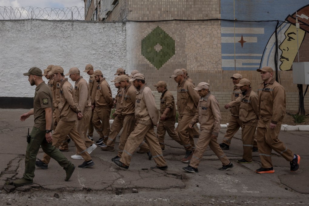 Inmates walk in a prison yard following a government offer to recruit some convicts for the military, in a prison colony in the Kyiv region. Photo: Reuters