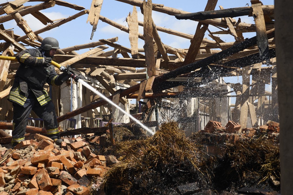 Ukrainian rescuers work at a site of a rocket strike near Kharkiv on Thursday. Photo: EPA-EFE