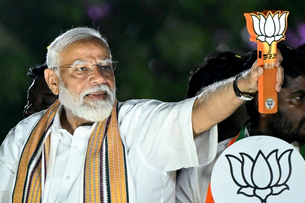 Narendra Modi, India’s Prime Minister and leader of the ruling Bharatiya Janata Party, holds the party symbol during a campaign rally. Photo: AFP/File
