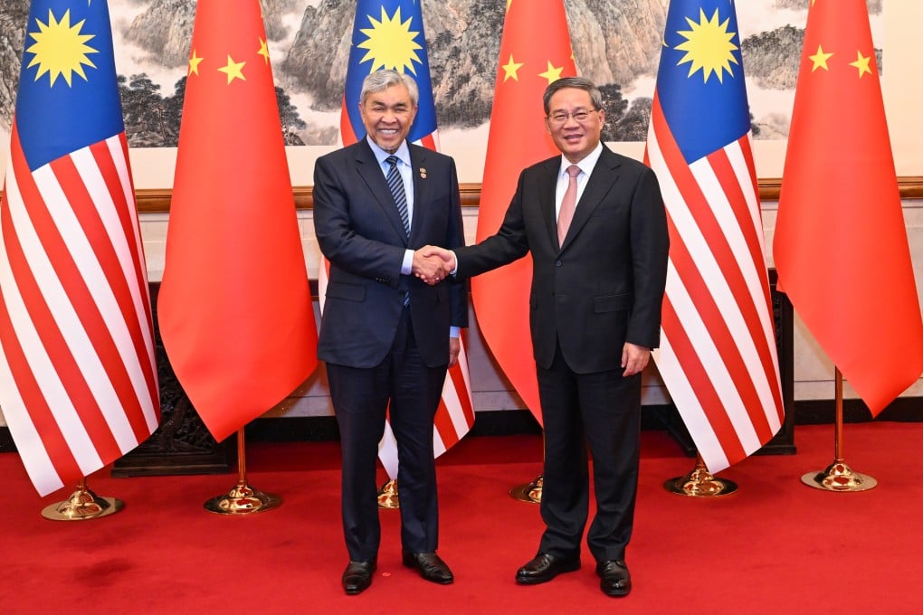 Chinese Premier Li Qiang shakes hands with Malaysia’s Deputy Prime Minister Ahmad Zahid Hamidi (left) in Beijing on May 29. Photo: Xinhua