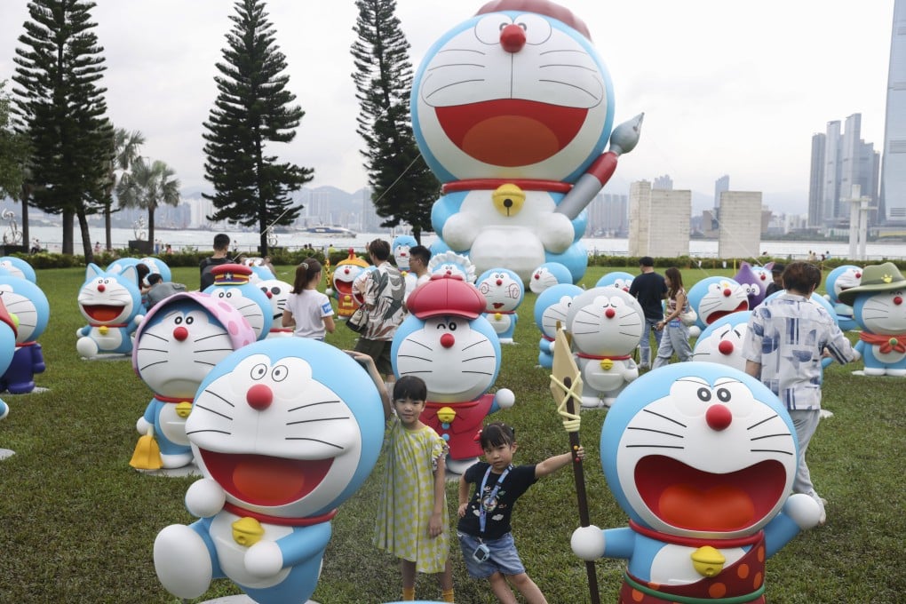 Visitors pose for pictures with statues of Japanese cartoon character Doraemon during the “100% Doraemon & Friends” tour in Sai Ying Pun on May 25. Photo: Yik Yeung-man