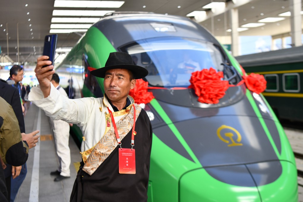 A passenger takes a selfie in front of a bullet train during the opening of the Lhasa-Nyingchi railway in southwest China’s Tibet autonomous region in June 2021. Photo: Xinhua