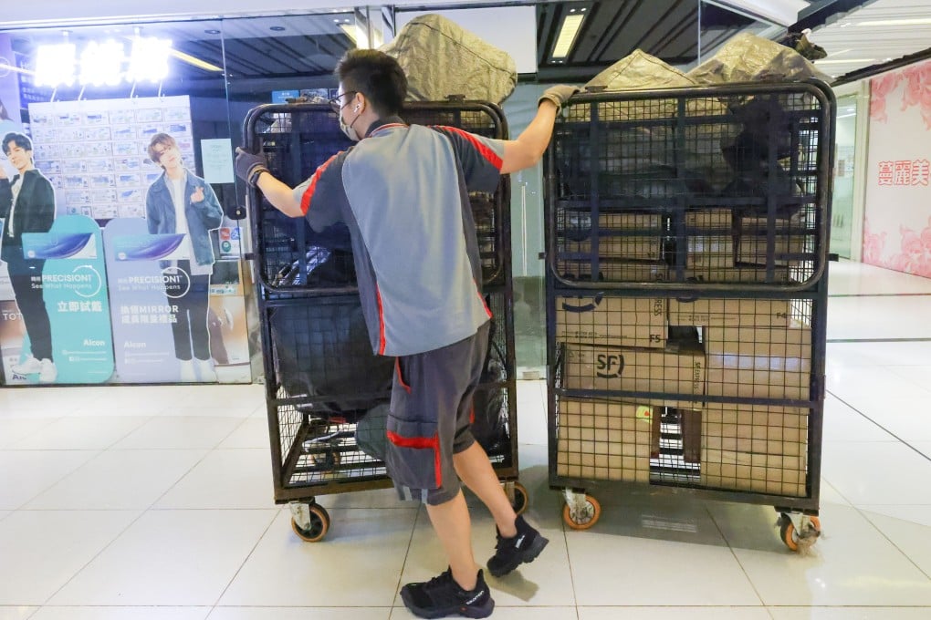 An SF Express worker moves packages for delivery at Nan Fung Plaza in Hong Kong’s Tseung Kwan O district on March 4, 2022. Photo: Dickson Lee