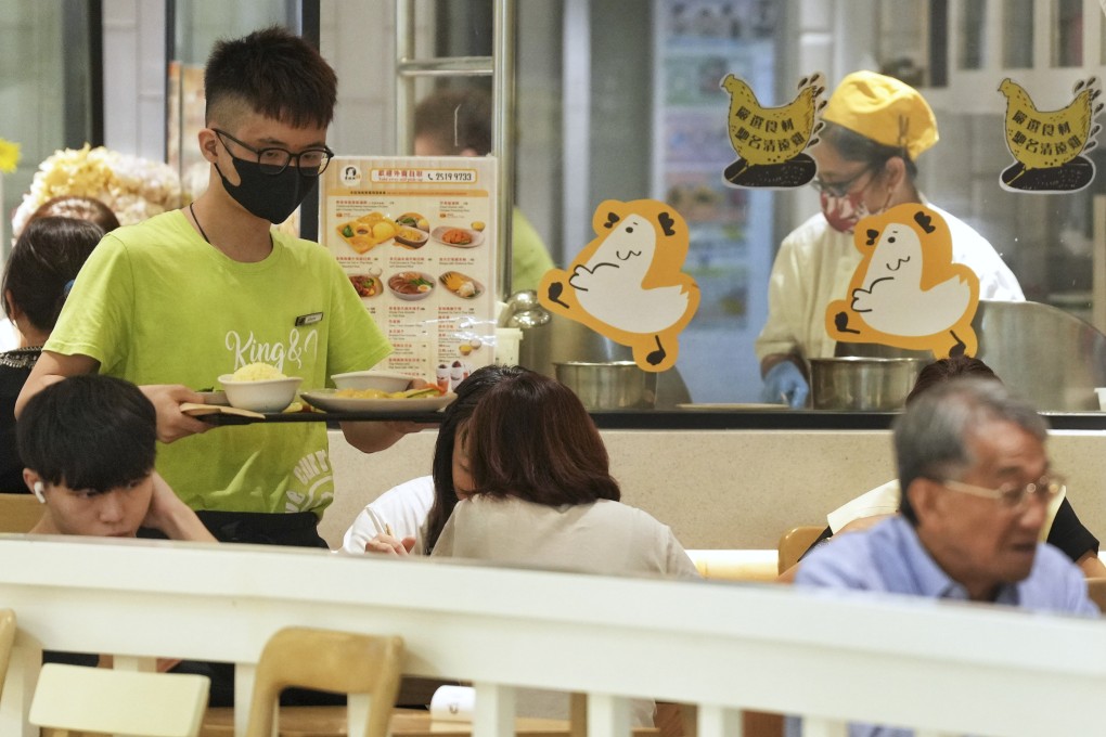 A server delivers food to customers in 2023. 
The behaviour of workers in restaurants and the wider service industry has come under scrutiny amid the Hong Kong government’s efforts to improve the city’s standing as a tourism destination. Photo: Elson Li