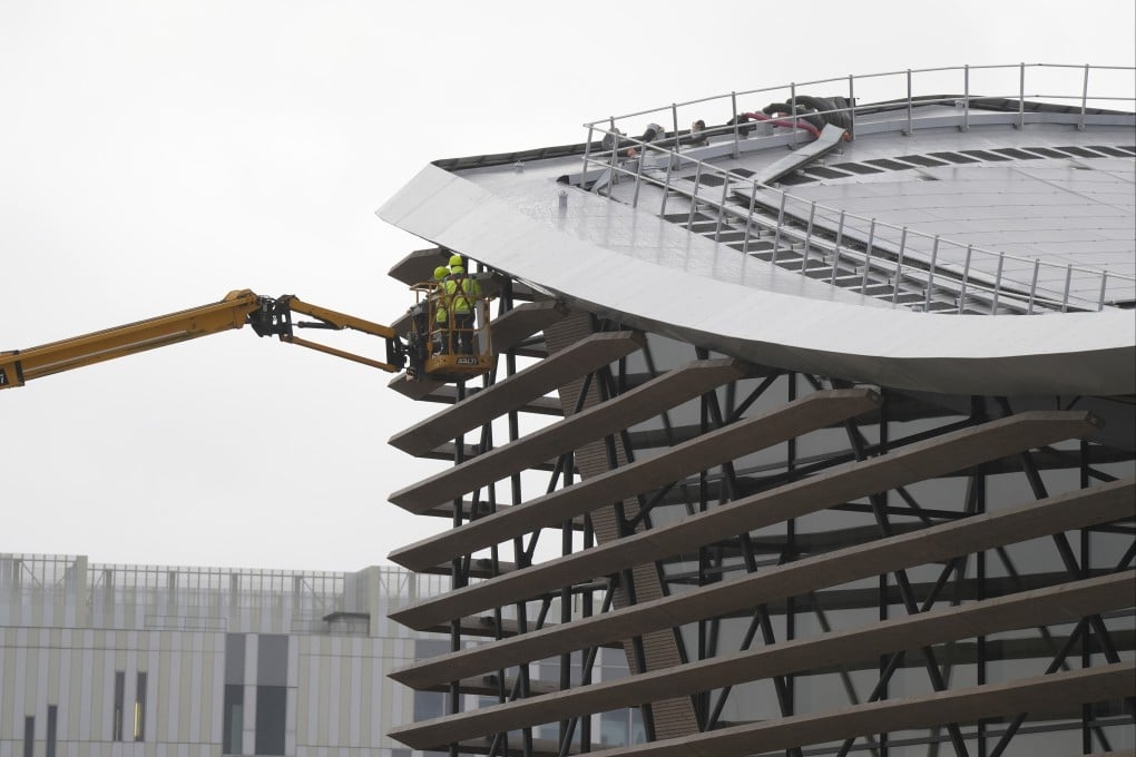 Workers on a crane at the Aquatics Centre under construction in Paris, where swimming events will take place during the 2024 Olympics. Organisers are employing sustainable practices in areas from venue construction to food provision, but some say their efforts aren’t enough. Photo: AP