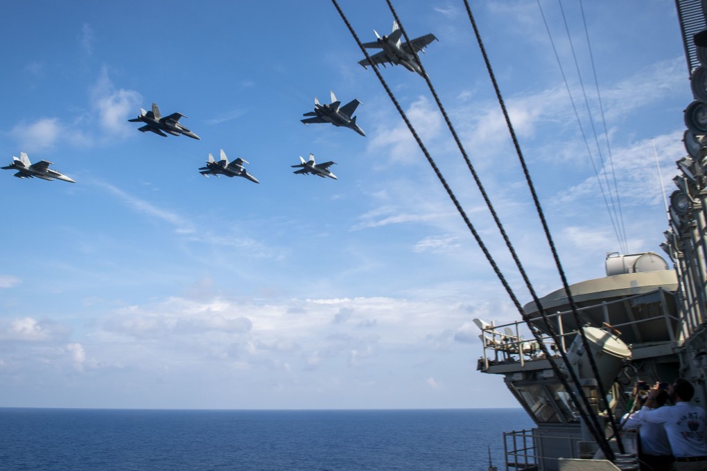 Royal Malaysian Air Force jets fly alongside US aircraft above the USS Theodore Roosevelt carrier during a scheduled deployment to the South China Sea in 2021. Photo US Navy/Handout