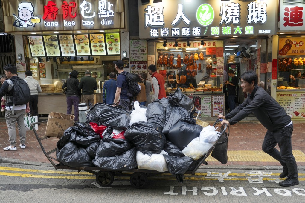 Workers moving rubbish with a trolley in Wan Chai. Photo: Sam Tsang