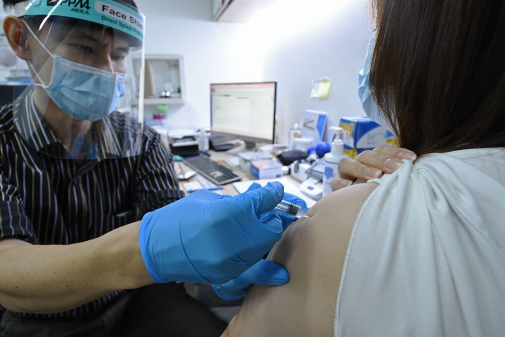 A woman receives a dose of Covid vaccine at a private clinic in Singapore in 2021. The health ministry said multiple studies have shown that Covid-19 vaccination reduces the risk of death. Photo: Xinhua