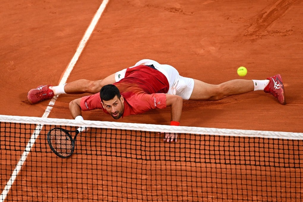 Novak Djokovic slides at the net for a forehand against Francisco Cerundolo during their men’s singles fourth round match at the French Open. Photo: Getty Images