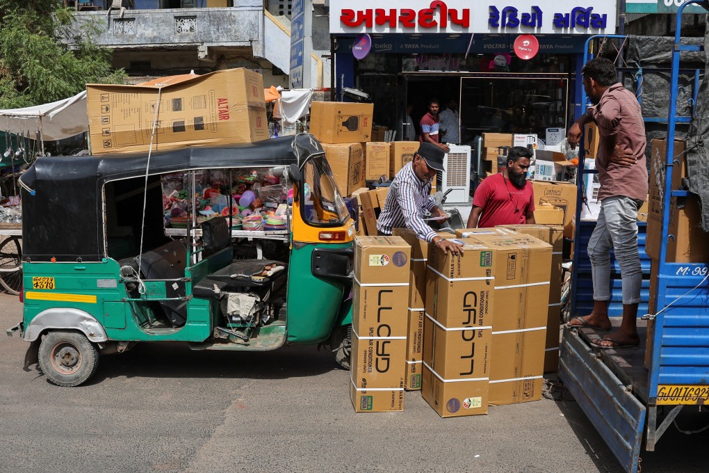 Workers count boxes of air conditioners outside a shop during a heatwave in Ahmedabad, India, on May 30. Estimates suggest India will overtake China as the largest consumer of air conditioning around 2045. Photo: Reuters