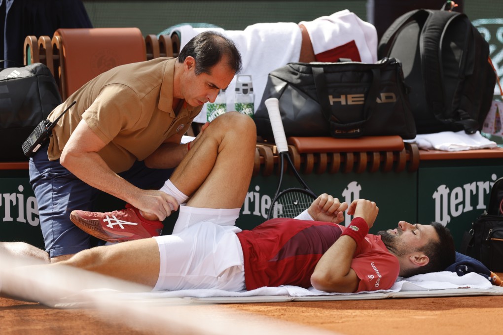 Djokovic receives assistance during his match on Monday. He withdrew from the tournament the next day. Photo: AP