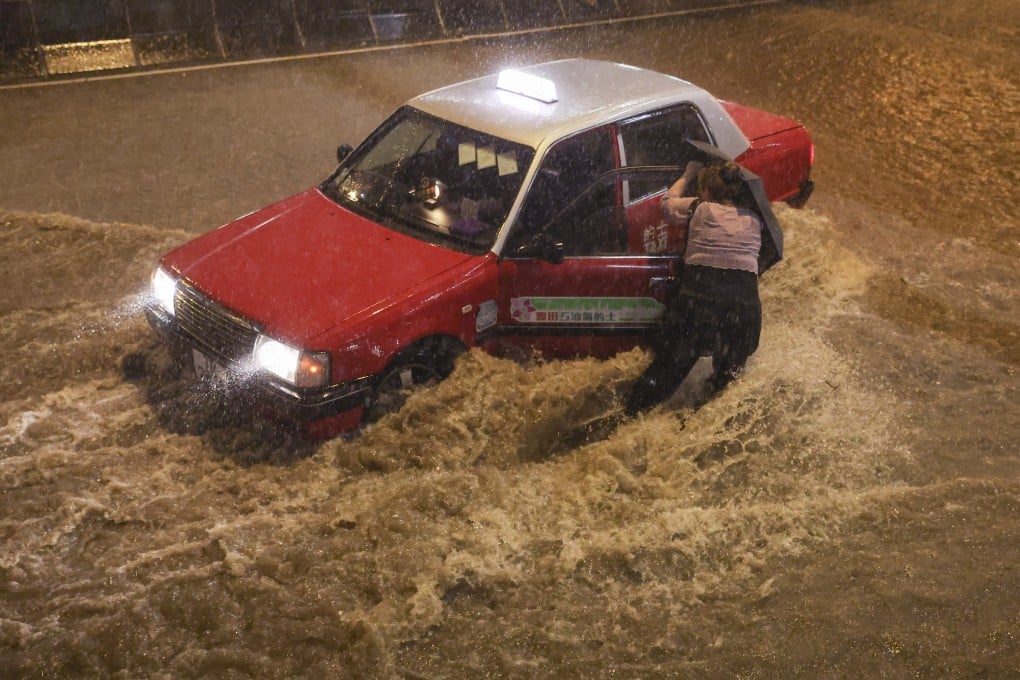 A woman tries to get into a taxi in Choi Hung during the black rainstorm warning on September 8. Frequent complaints about taxi drivers are surely insignificant against the millions of safe miles Hong Kong taxis drive to keep the wheels of the economy turning. Photo: Edmond So
