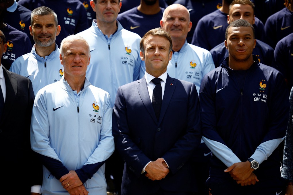 French President Emmanuel Macron flanked by coach Didier Deschamps (left) and striker Kylian Mbappe on Monday. Photo: EPA-EFE
