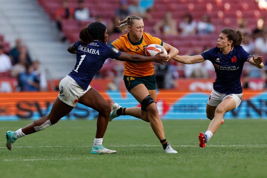Levi brushes off the tackles of France’s Seraphine Okemba (left) and Marie Dupouy on her way to a try in the World Rugby Sevens final in Madrid on Sunday. Photo: AFP