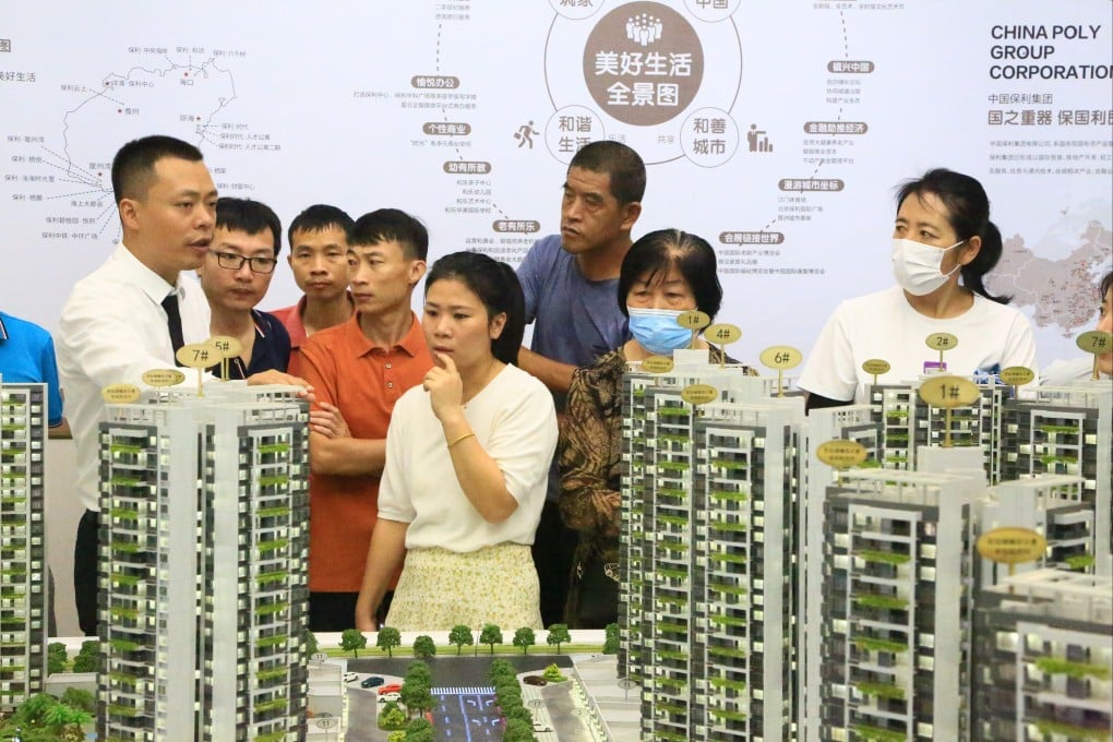 Local residents look at a model of a Poly project at a showroom in Sanya, Hainan Province. Photo: VCG via Getty Images