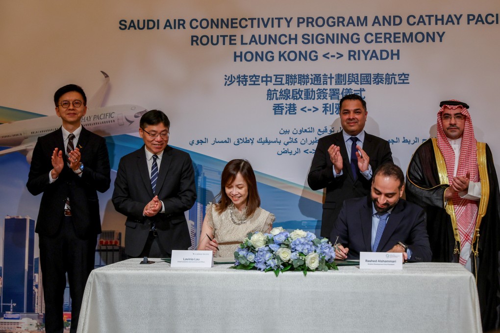 Lavinia Lau Hoi-zee, Cathay’s Chief Customer and Commercial Officer signs the agreement alongside Rashed Alshammari, vice president of Aviation Development for Saudi Arabia. Standing, from left to right, are Cathay CEO Ronald Lam, transport minister Lam Sai-hung, Saudi Air Connectivity Programme CEO Majid Khan and Consul-General of Saudi Arabia Hamad Aljebreen. Photo: Edmond So