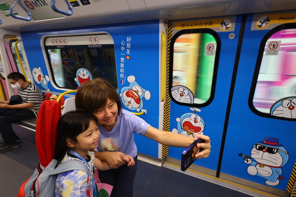 Passengers take a selfie on a Doraemon-themed MTR train on the East Rail Line in Hong Kong on June 1. Photo: Dickson Lee