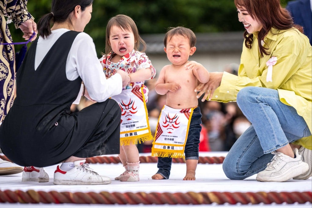 Children held by their parents at a “Baby-cry Sumo” match at the Sensoji temple in Tokyo. Photo: AFP