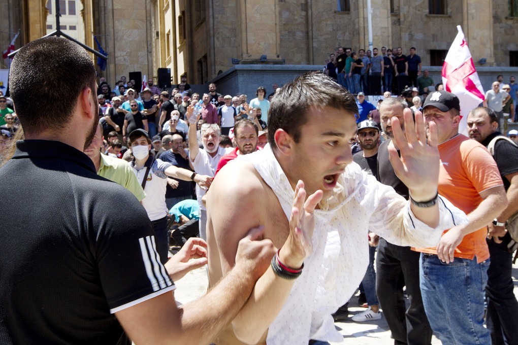 LGBTQ opponents push a man as they block the capital’s main avenue to a pride march in Tbilisi, in 2021. Photo: AP