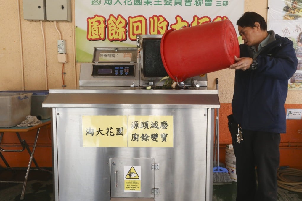 A worker uses a food waste composter at a housing estate in Kowloon in Hong Kong in 2017. Recent discussions of waste management in Hong Kong have largely overlooked the benefits of composting. Photo: K.Y. Cheng