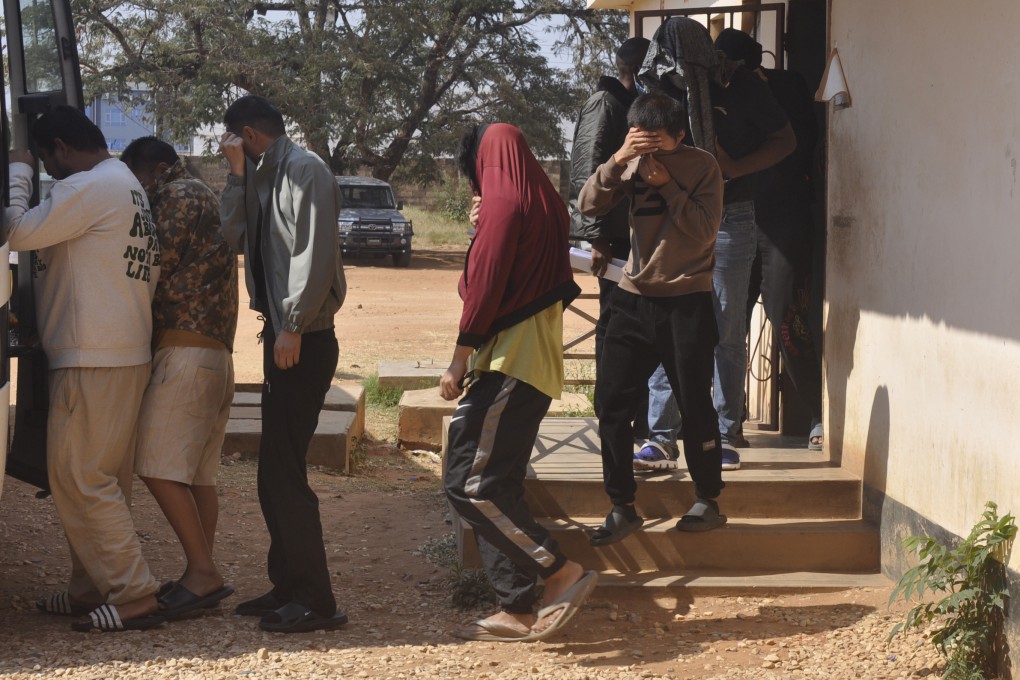 A group of Chinese nationals is seen outside court in Lusaka, Zambia, on Friday. Photo: AP