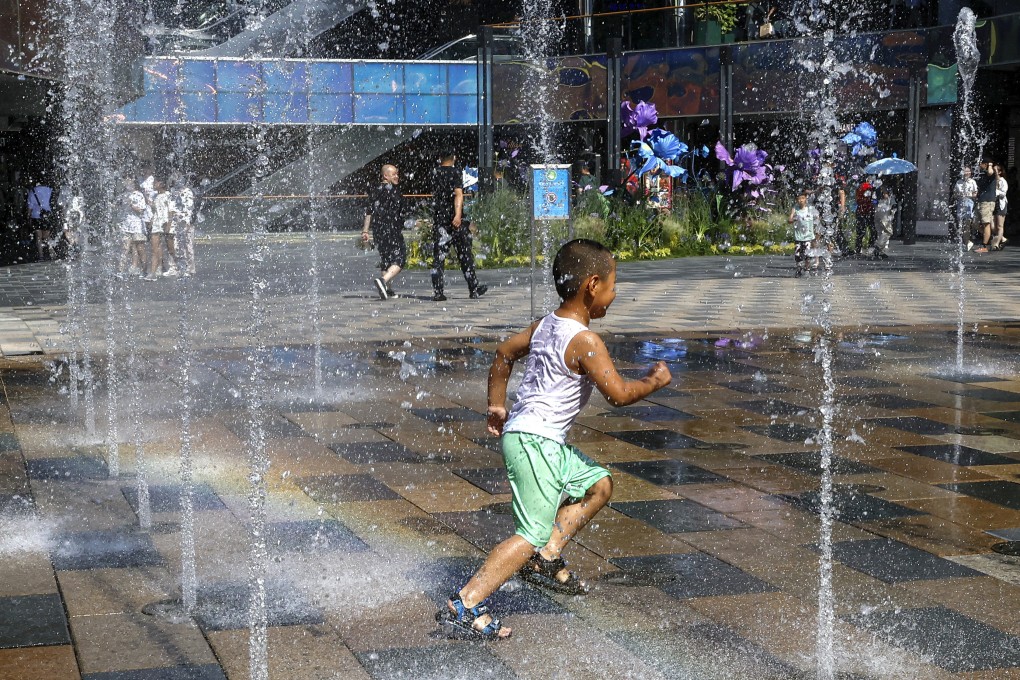 A child cools down in a fountain during last year’s heatwave in Beijing. Photo: Reuters