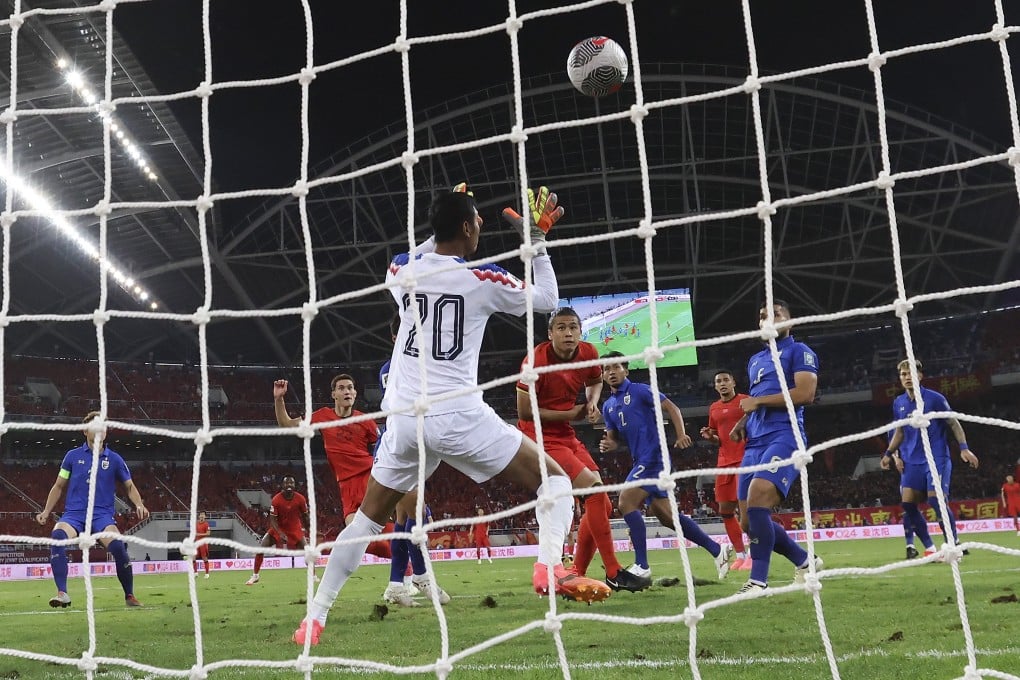 China needed a late equaliser from Behram Abduweli (left of Thai goalkeeper Saranon Anuin) to salvage a 1-1 draw with Thailand. Photo: Xinhua