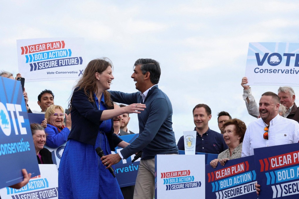 Britain’s Prime Minister Rishi Sunak (right) greets local candidate Michelle Donelan during his visit to Melksham Town FC in southwest England on June 7. Photo: AFP