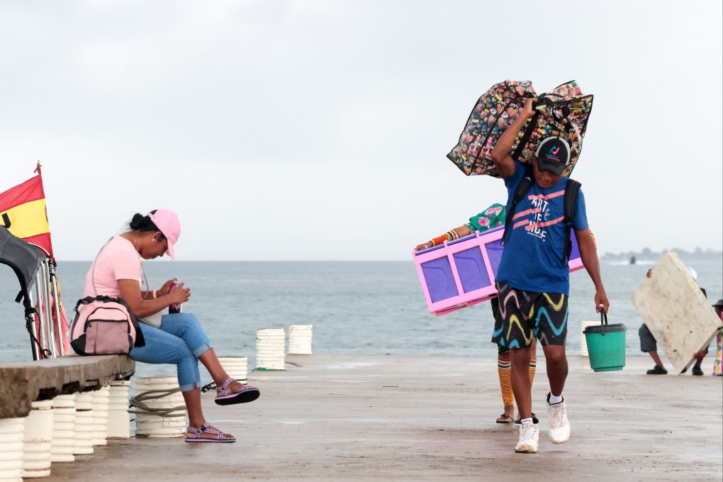 A former resident of an indigenous island town in Panama makes his way to new housing constructed by the government on the mainland due to rising sea levels. Photo: EPA-EFE