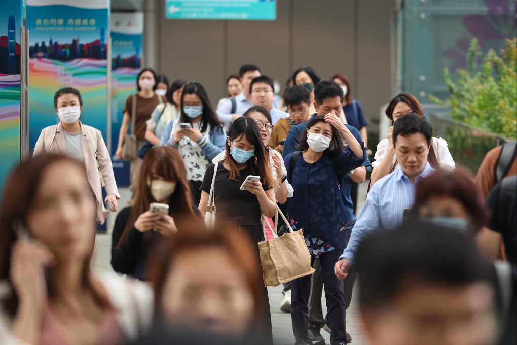 Civil service staff leave work at government headquarters. Photo: Edmond So