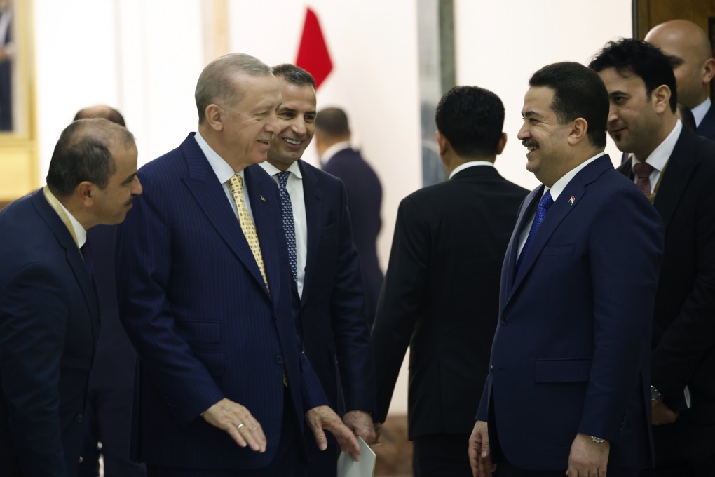 Turkish President Recep Tayyip Erdogan (second left) and Iraqi Prime Minister Mohammed Shia al-Sudani (foreground, right) attend the ceremony to sign a four-way memorandum of understanding between Iraq, Turkey, Qatar and the UAE to cooperate in the Development Road project, in Baghdad, Iraq, on April 22. Photo: AP