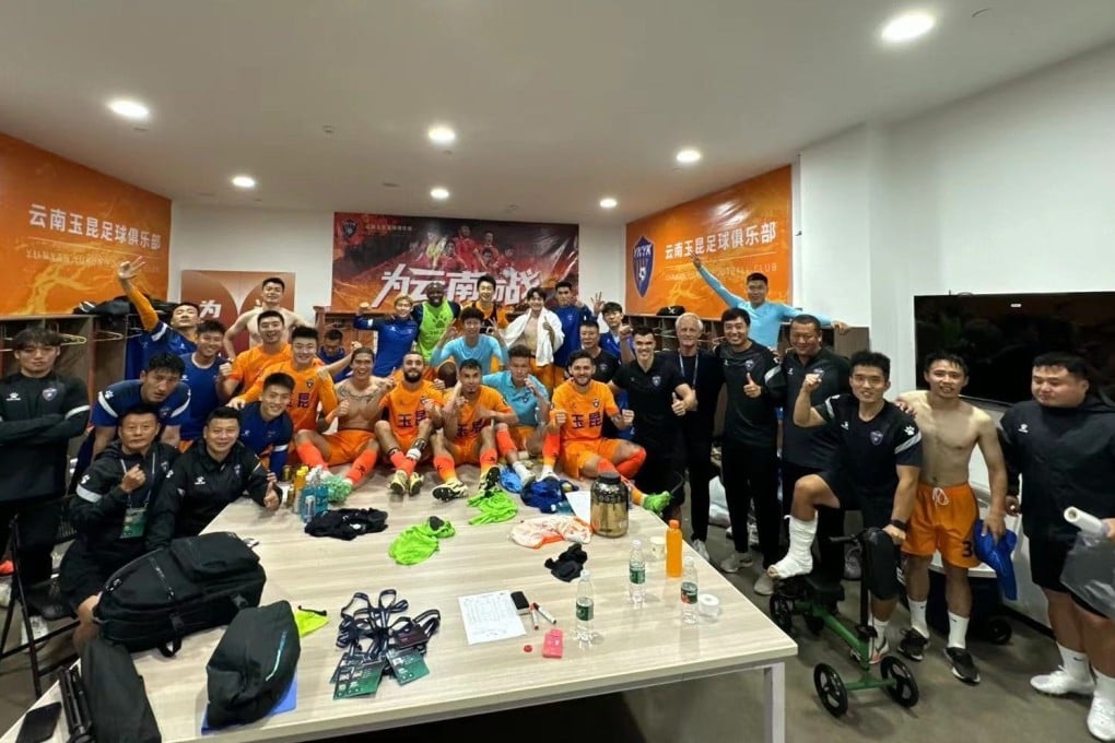 Jorn Andersen (seventh from right) joins the players in the dressing room. Photo: X/@andersen_jrn
