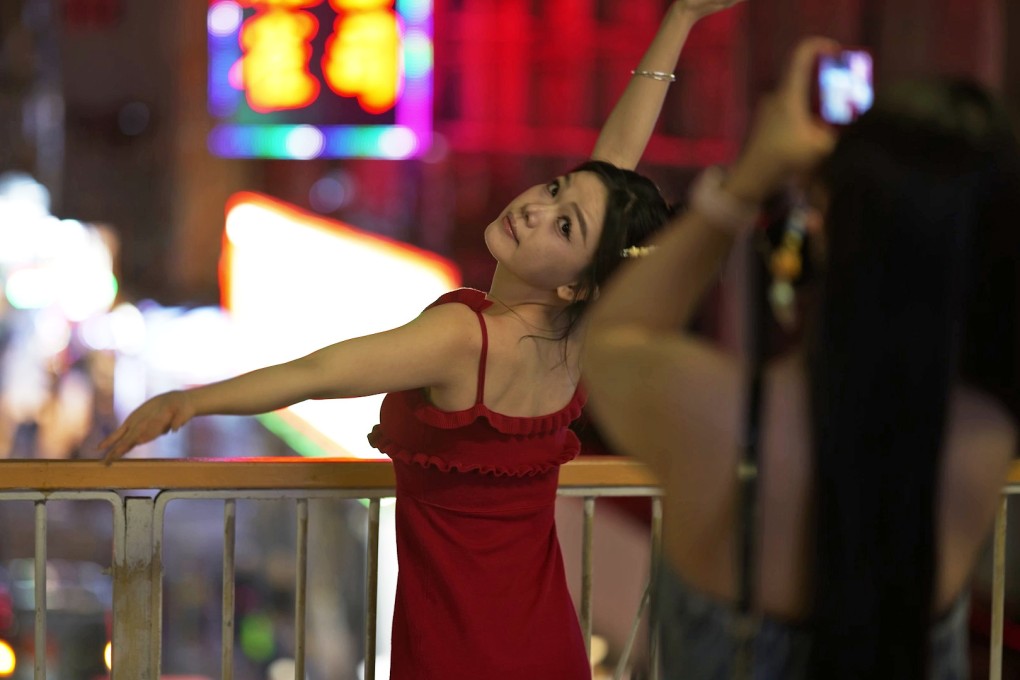 A tourist poses for a photograph in Hong Kong. Photo: SCMP / Daniel Suen