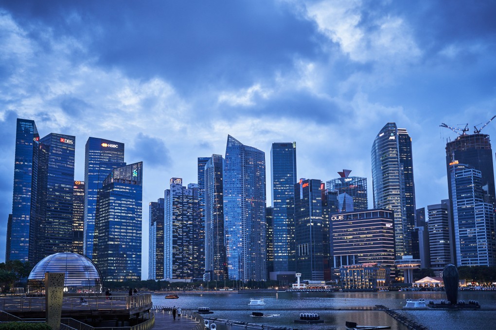 Buildings are seen illuminated at dusk in Singapore’s central business district. Lenders are trying to close loopholes that enabled a group of criminals from China to launder more than US$2.2 billion through at least 16 financial institutions in Singapore. Photo: Bloomberg