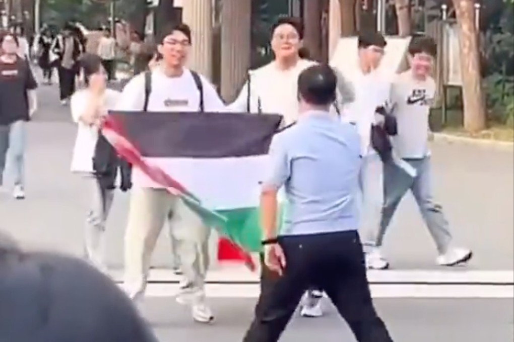 A high school student unfurls a Palestinian flag after taking a college entrance exam. Photo: Handout