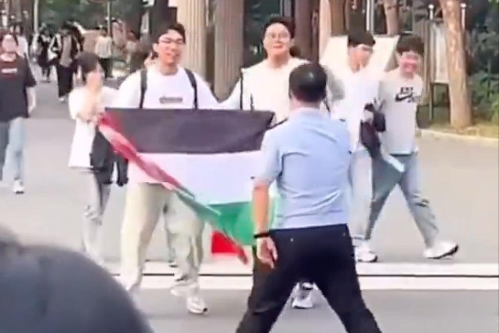 A high school student unfurls a Palestinian flag after taking a college entrance exam. Photo: Handout