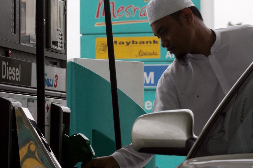 A man fills his car with fuel in Kuala Lumpur. Malaysian Prime Minister Anwar Ibrahim has said the diesel subsidy cut was aimed at the “uber rich and foreigners”. Photo: AFP