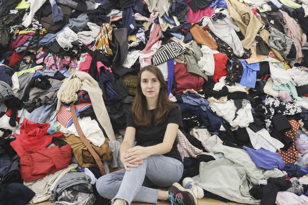 Redress’ Aurianne Ricquier with a mountain of clothes from a month-long donation drive in Hong Kong. The charity will repurpose, resell, repair and recycle what it can – saving the clothes from landfill. Photo: Jonathan Wong