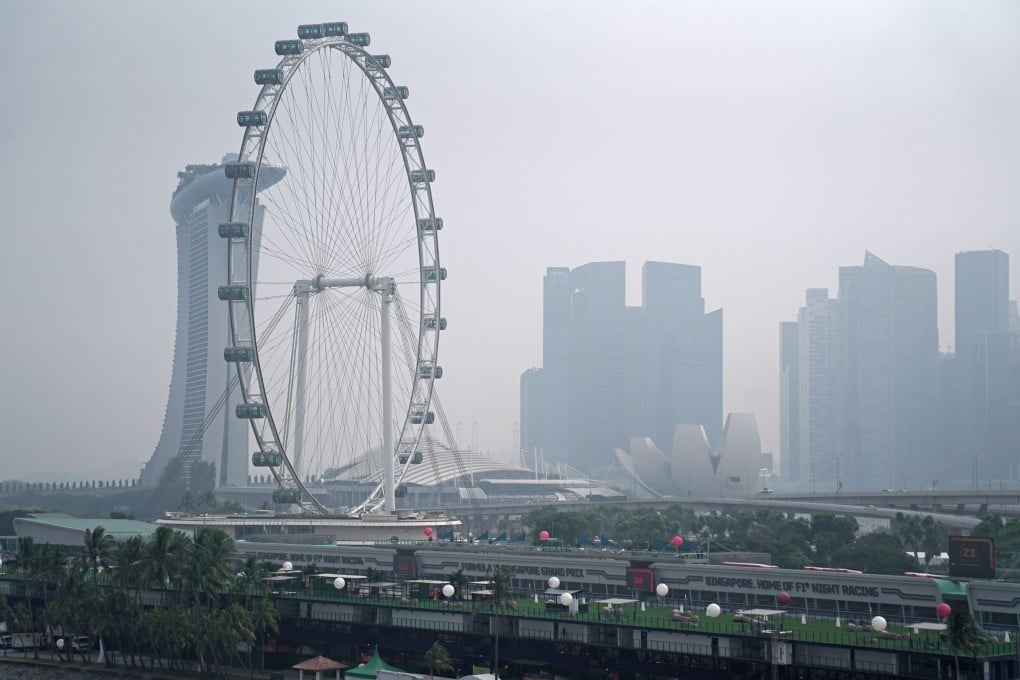 Haze shrouds the Singapore Flyer observation wheel and Marina Bay Sands in 2019. Photo: Bloomberg