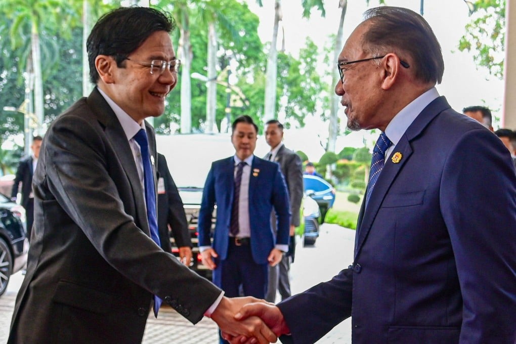 Malaysia’s Prime Minister Anwar Ibrahim and Singapore’s Prime Minister Lawrence Wong shaking hands ahead of their meeting in Putrajaya. Photo: AFP