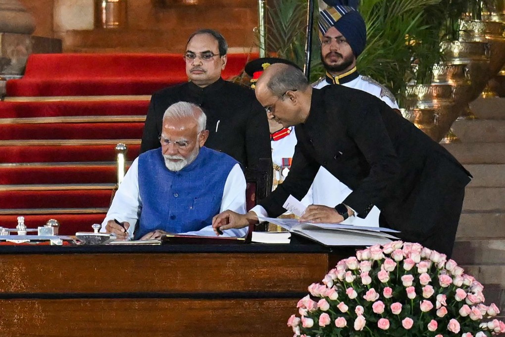 India’s Bharatiya Janata Party leader Narendra Modi signs after taking the oath of office for a third term as the country’s prime minister during the oath-taking ceremony in New Delhi. Photo: AFP