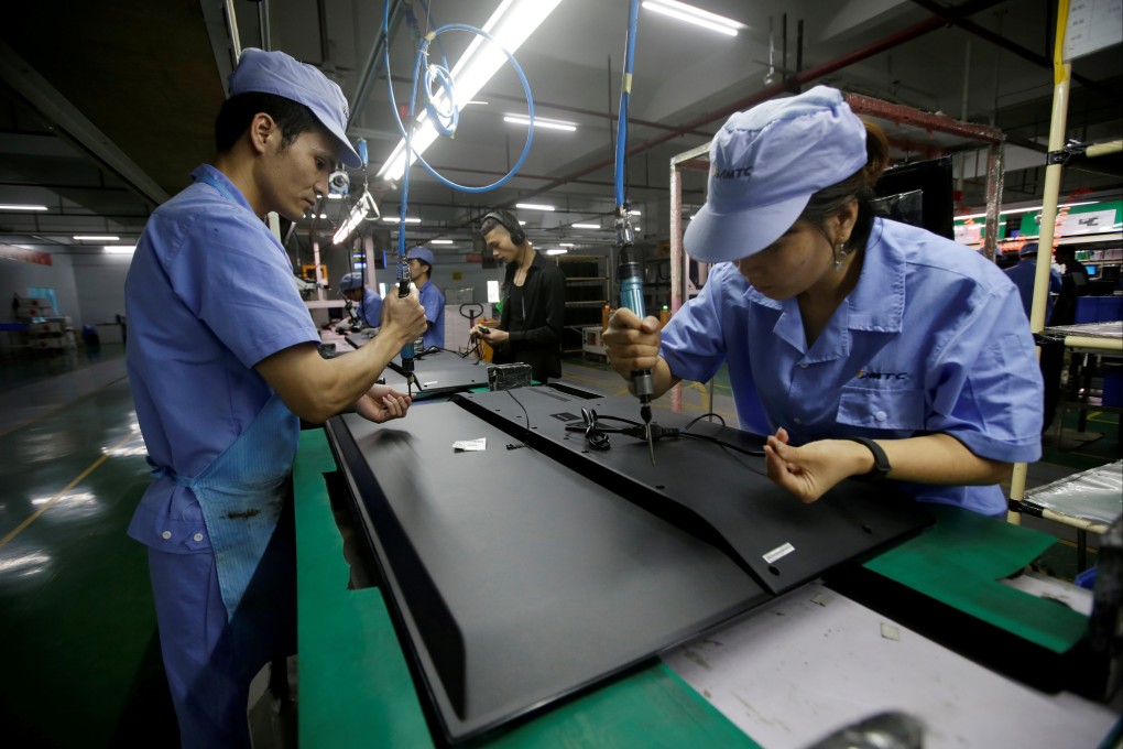Factory workers assemble televisions in Shenzhen, China. Photo: Reuters