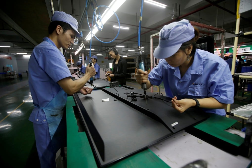 Factory workers assemble televisions in Shenzhen, China. Photo: Reuters